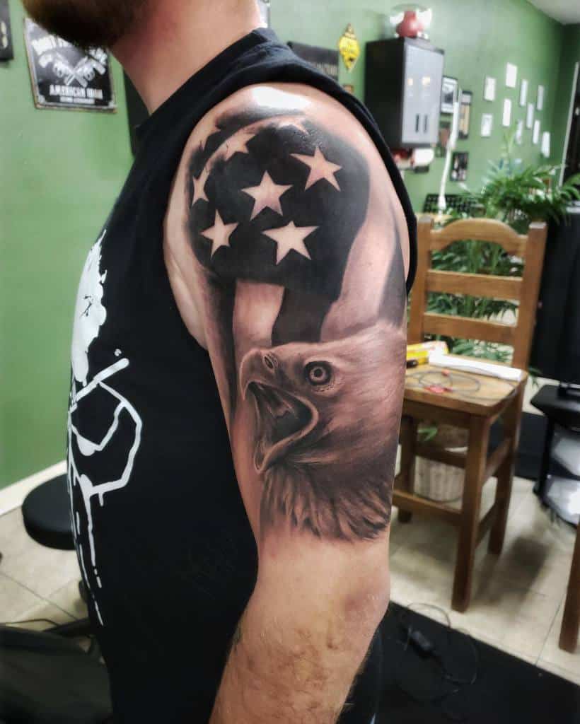 Man's upper arm tattoo featuring an eagle head and American flag