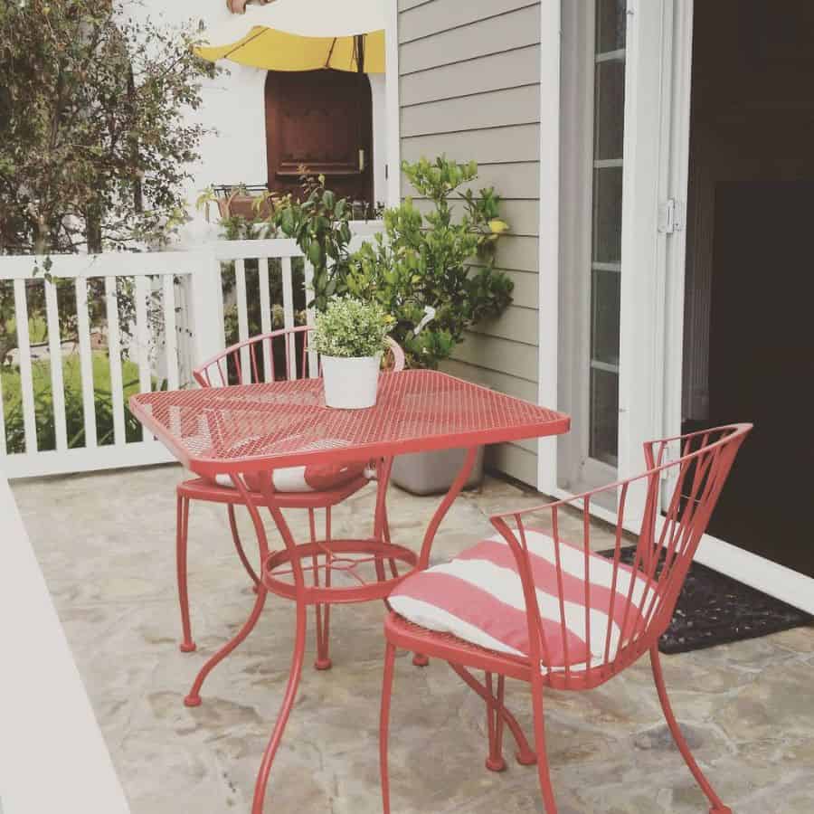 small budget patio with red table and chairs 