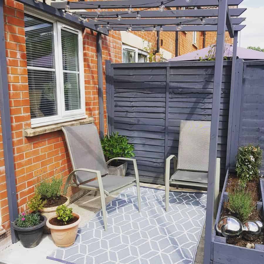 small corner backyard patio with pergola 