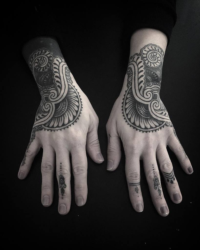 Intricate blackwork paisley tattoos  featuring fine details and elegant ornamental patterns.