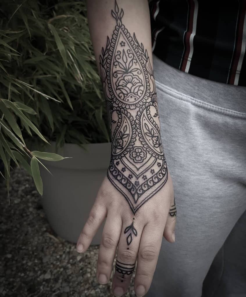 Elegant henna-inspired tattoo with intricate floral and geometric patterns