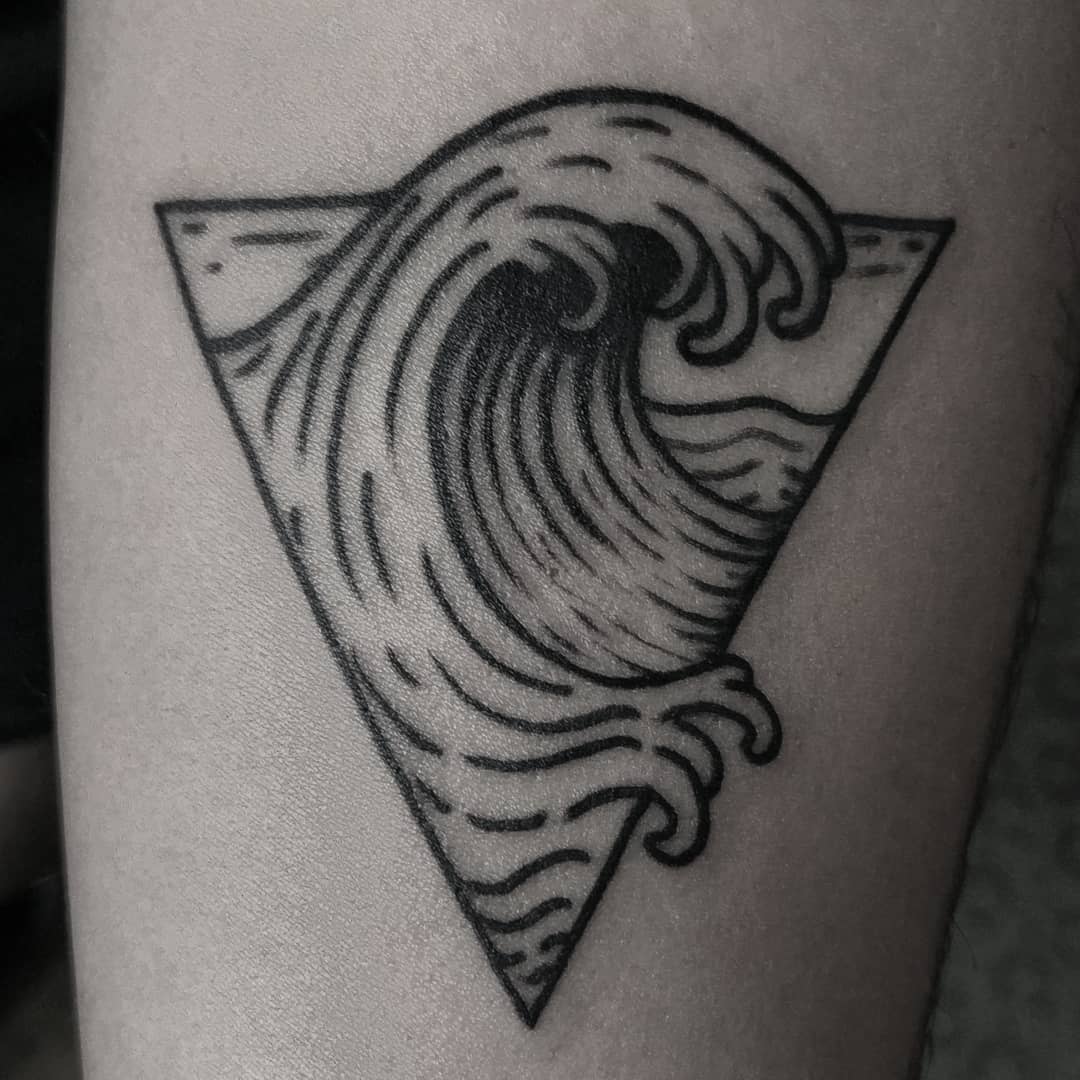 Minimalist tattoo featuring a wave inside an inverted triangle