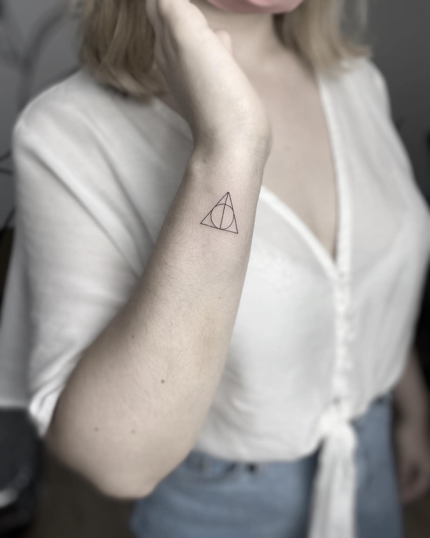 Triangular tattoo on the forearm