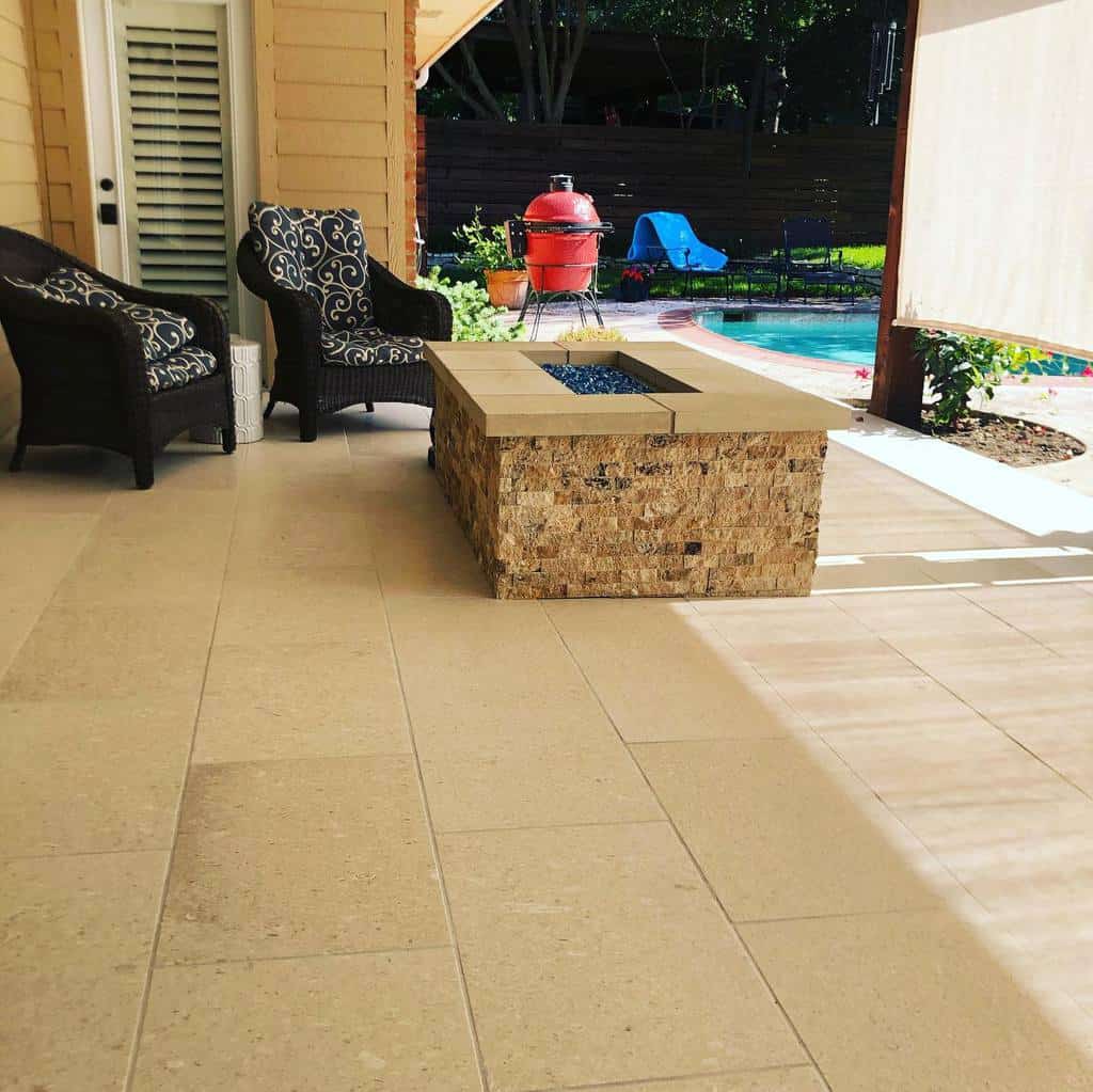 backyard paver patio stone fire pit pool wicker chairs