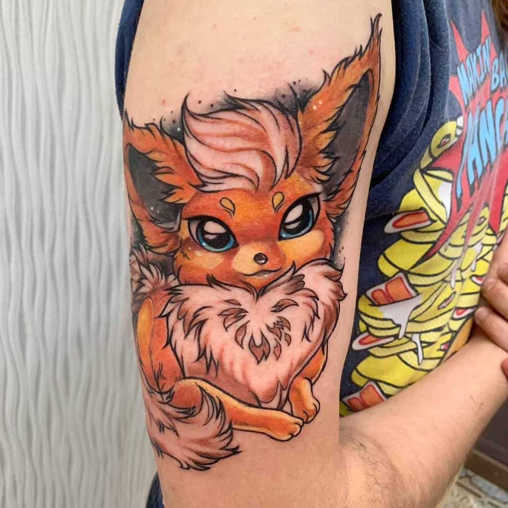 Vivid Flareon tattoo with bold colors and detailed fur design, showcasing a fiery and energetic expression