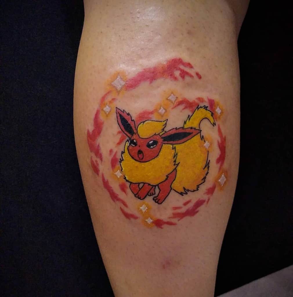 Dynamic Flareon tattoo surrounded by fiery swirls and sparkles, highlighting its bold and energetic nature