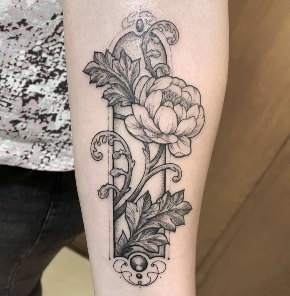 Elegant black-and-gray Art Nouveau tattoo of a blooming peony framed with intricate scrollwork and decorative details
