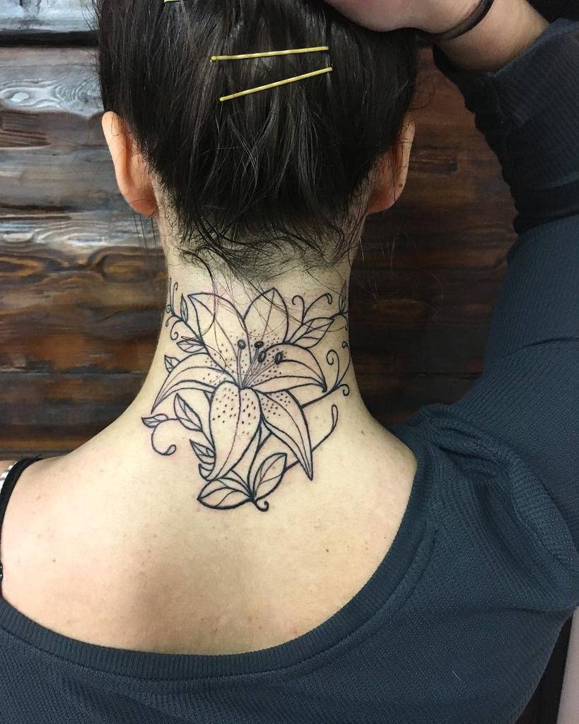 Neck tattoo of a large, intricate flower on the back of neck with someone's hand touching their hair
