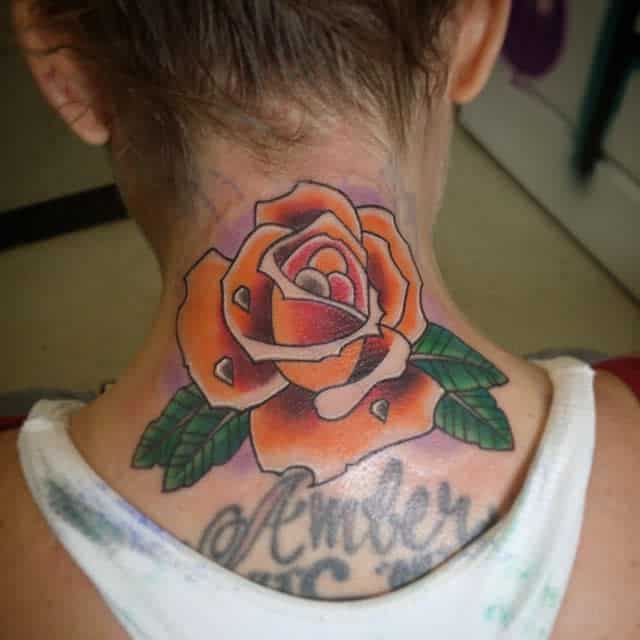 Close-up of a colorful rose tattoo gracing the back of neck showcasing intricate details
