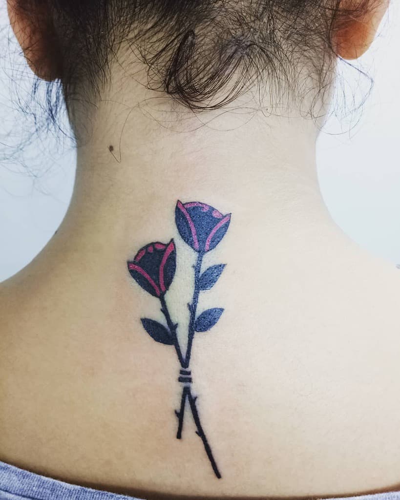 A neck tattoo featuring two roses with black stems and leaves, accented with red, elegantly graces the back of neck
