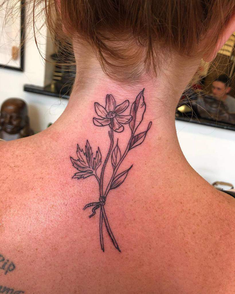 Line art floral tattoo on the back of neck, featuring delicate flowers and leaves