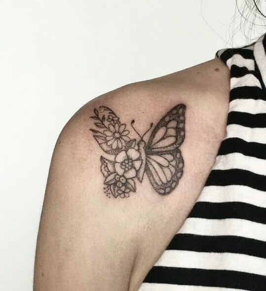 Butterfly tattoo with floral patterns on shoulder