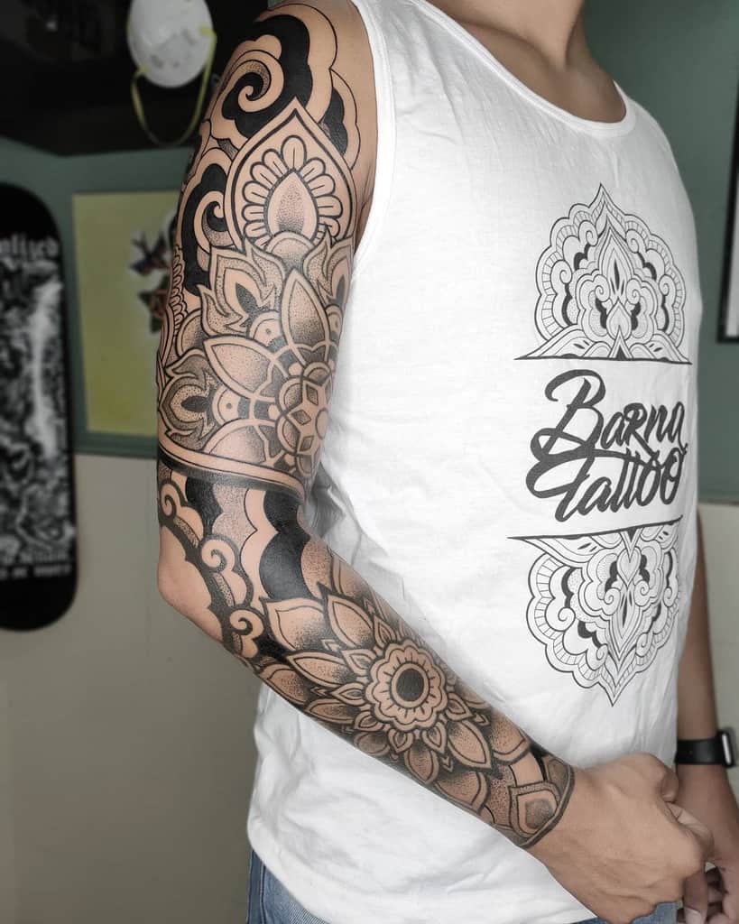 A man with an intricate floral mandala style sleeve tattoo