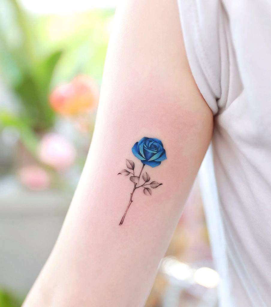 Blue rose tattoo on an upper arm