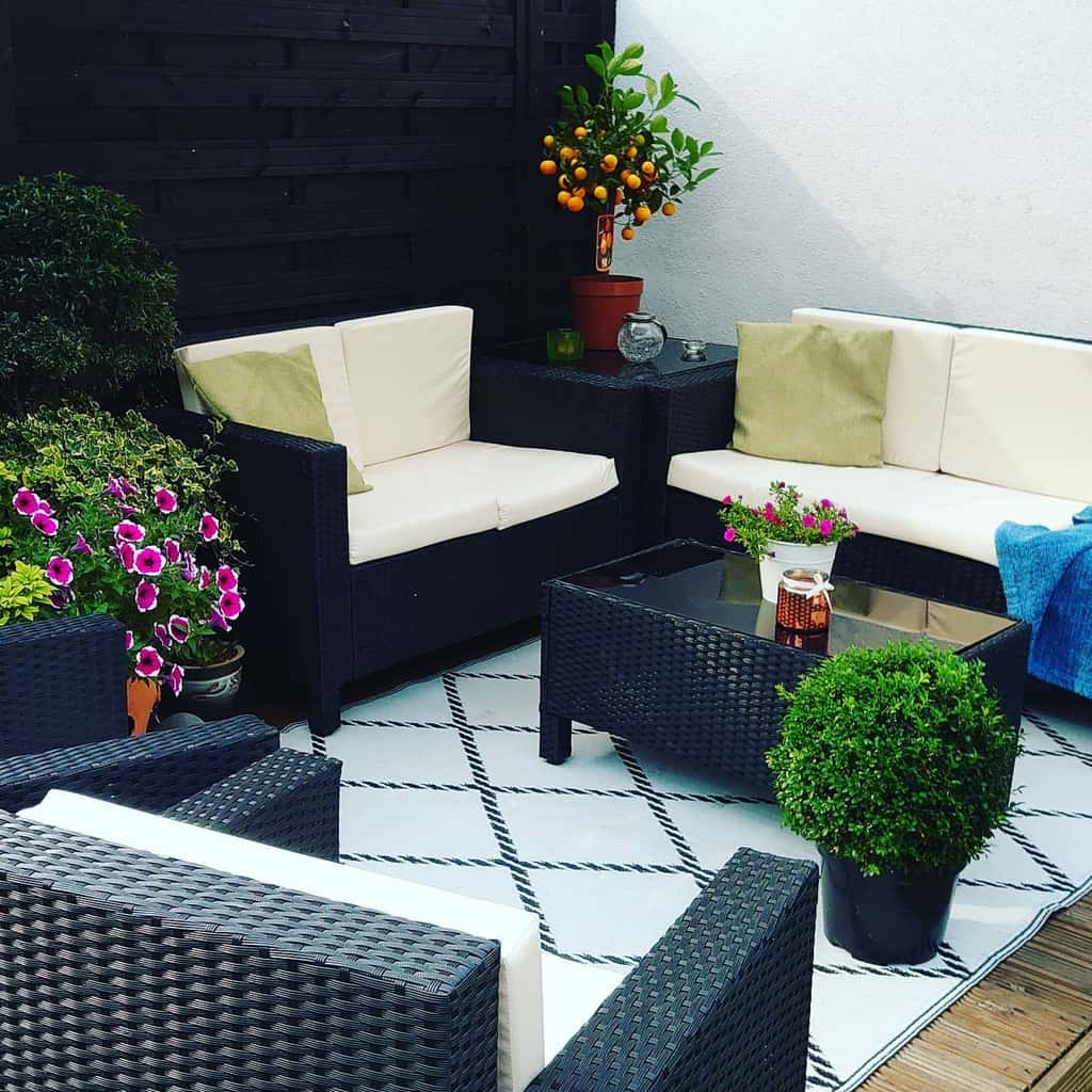 small patio garden with black wicker furniture 