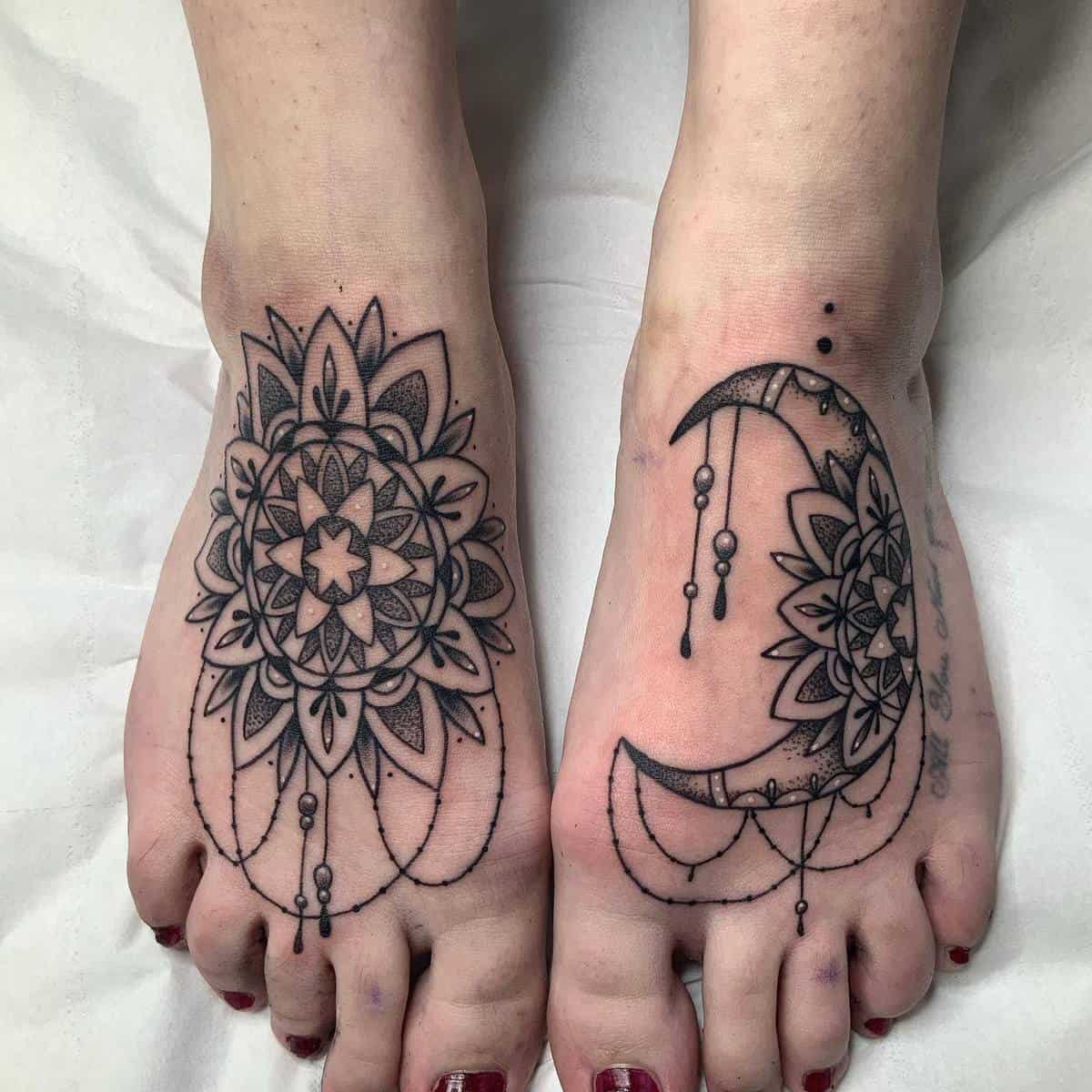 Feet with black ink tattoos; left foot has a floral mandala, right foot features a crescent moon with a floral design