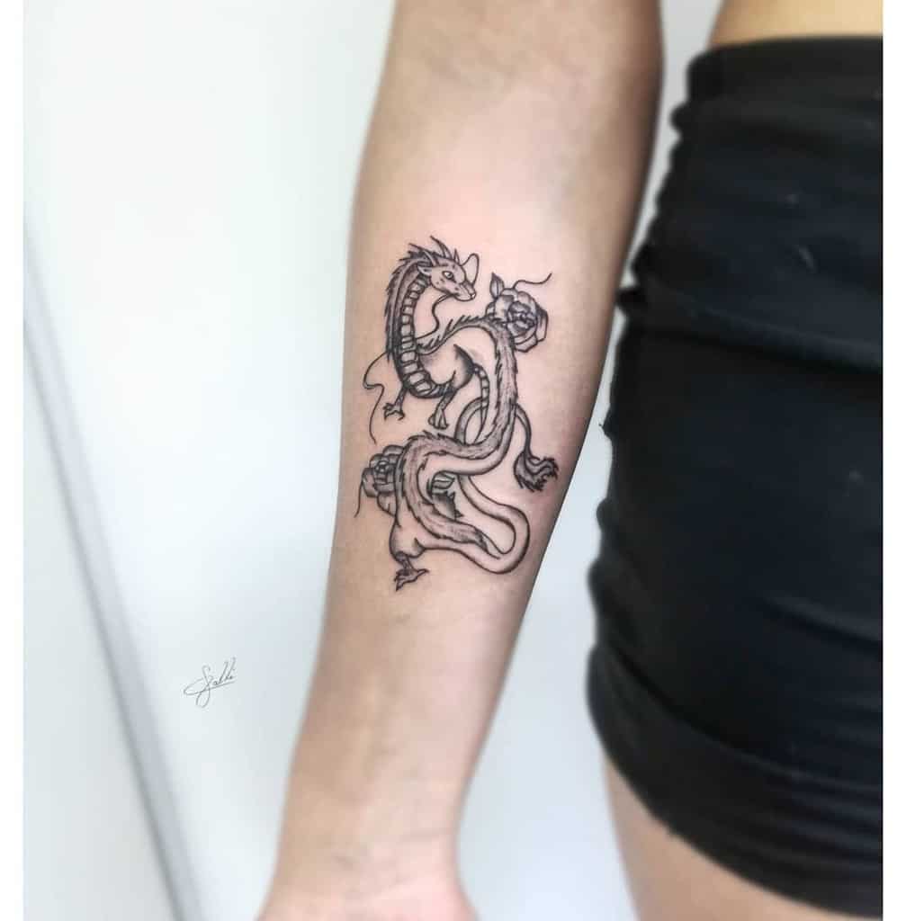 Black dragon tattoo on a woman's forearm