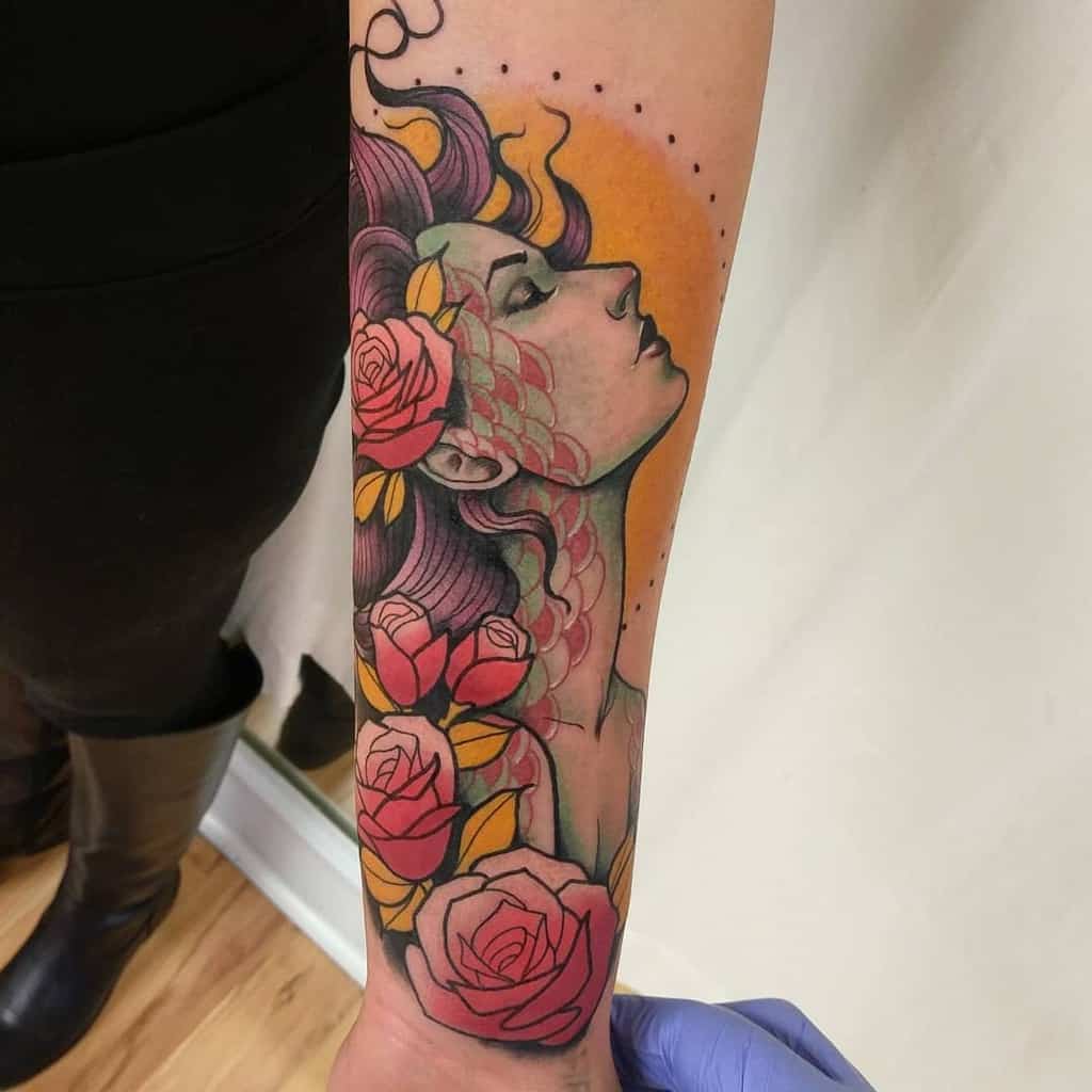 Colorful half sleeve tattoo of a woman's profile with roses and abstract patterns on a forearm