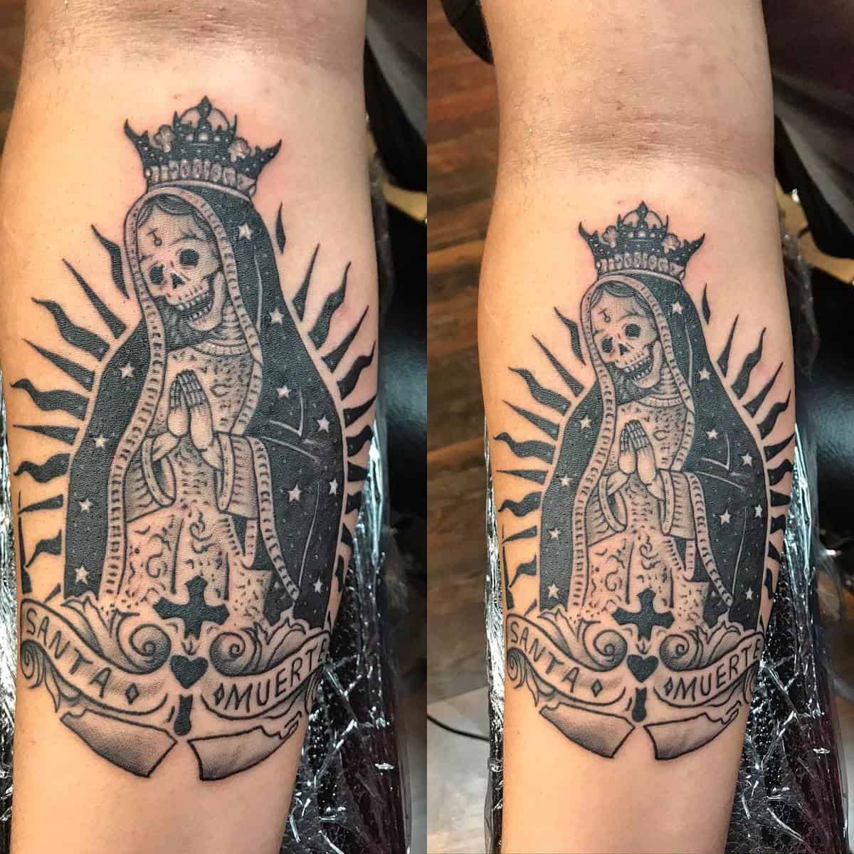 Santa Muerte tattoo on the forearm, featuring a crowned skeleton in a prayer pose, framed by radiant lines