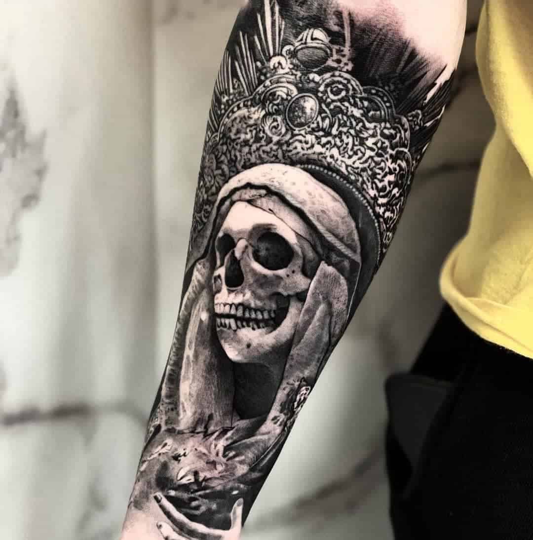 Detailed Santa Muerte forearm tattoo featuring a crowned skeleton, symbolizing death and royalty