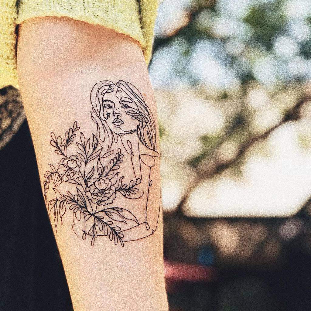 Line art tattoo featuring a woman surrounded by honeysuckle and floral details on the forearm