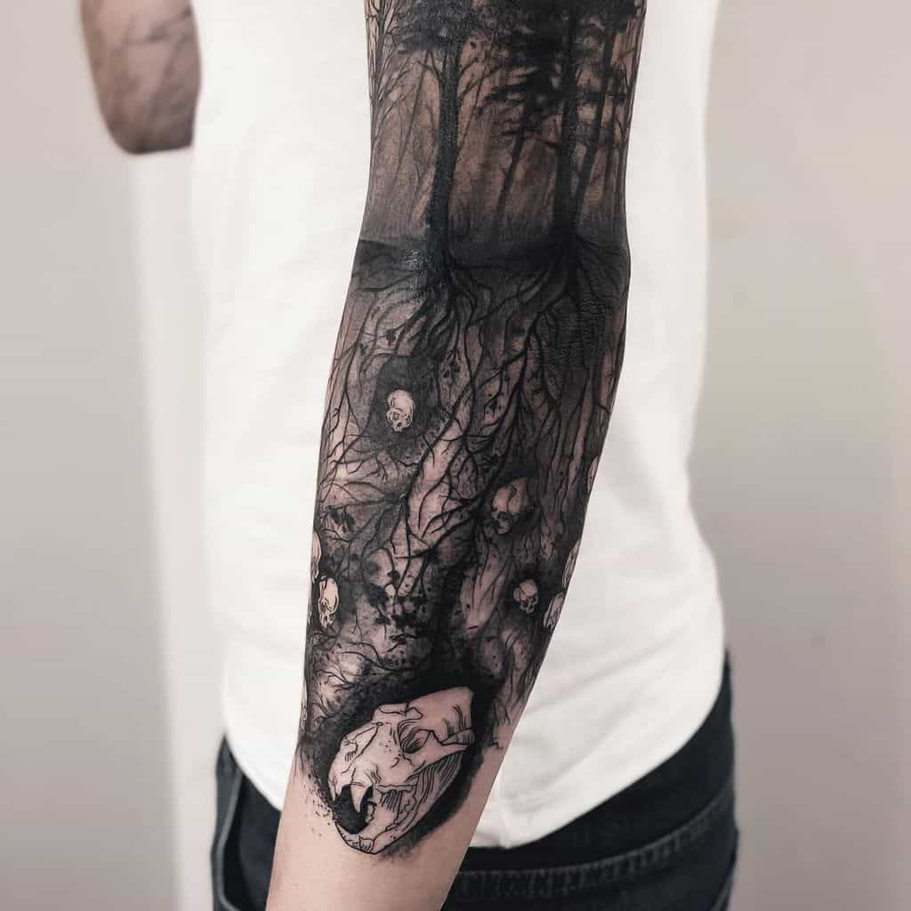 Dark forest tattoo featuring intricate tree roots intertwined with skulls and a haunting animal skull centerpiece, creating an eerie, underground narrative.
