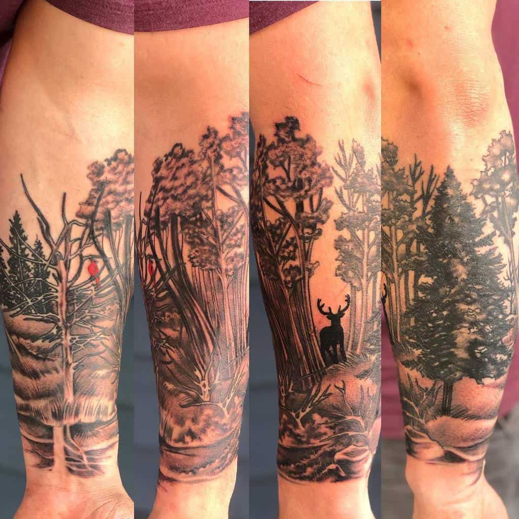 Full forearm tree silhouette tattoo with forest scenery and a deer, evoking a peaceful, natural wilderness atmosphere
