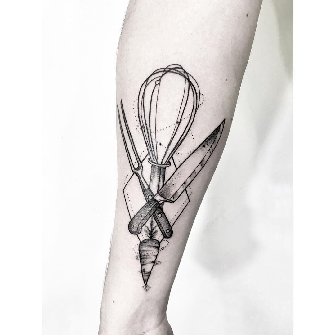 Forearm tattoo of a whisk, knife, and carrot crossed in a geometric design