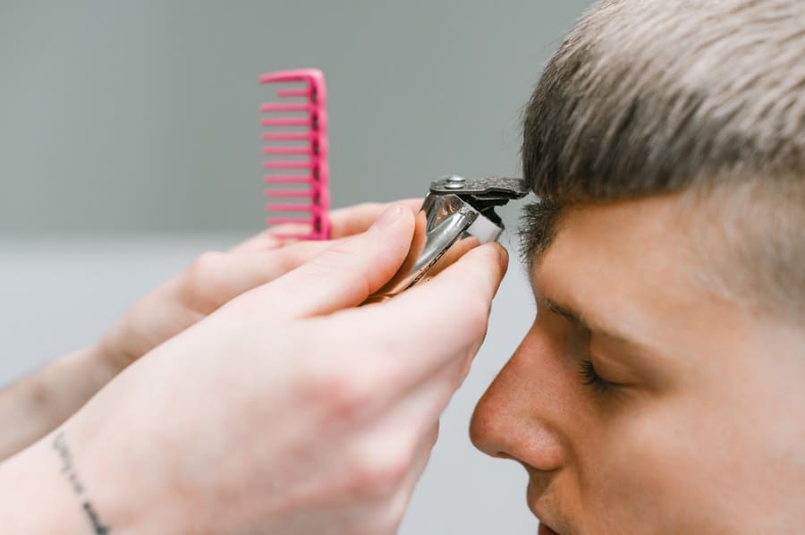 Man getting French crop haircut at barber's