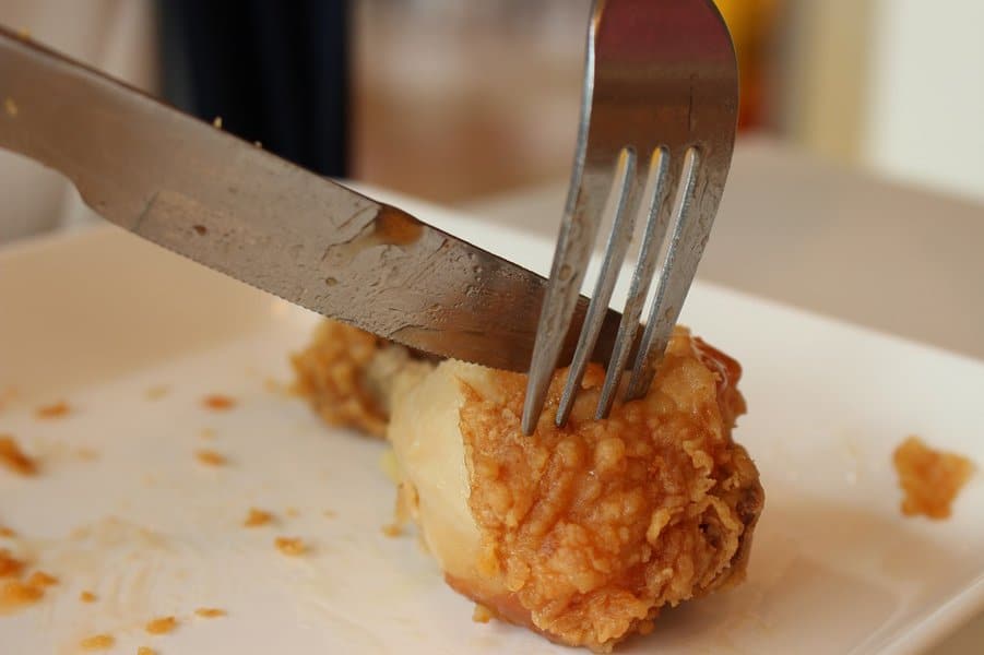 Fried chicken for lunch with fork and knife