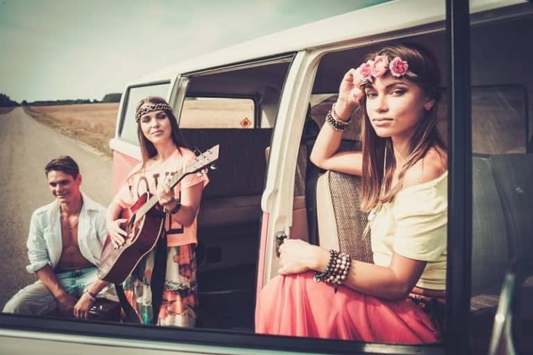 Friends On Roadtrip Dressed In 1970s Hippie Style