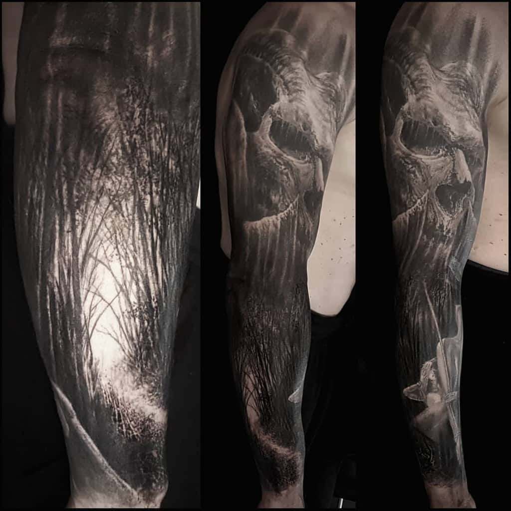 Tattoo sleeve featuring a dark forest and a skull design in black and gray tones