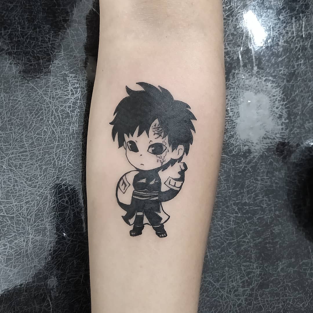 Tattoo of a chibi anime character with spiky hair and a gourd on the back of their arm
