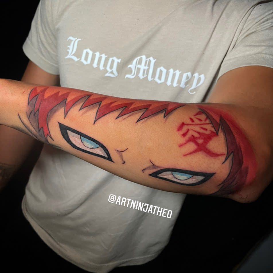 Forearm tattoo of an intense anime character Gaara with red hair and a symbol on the forehead
