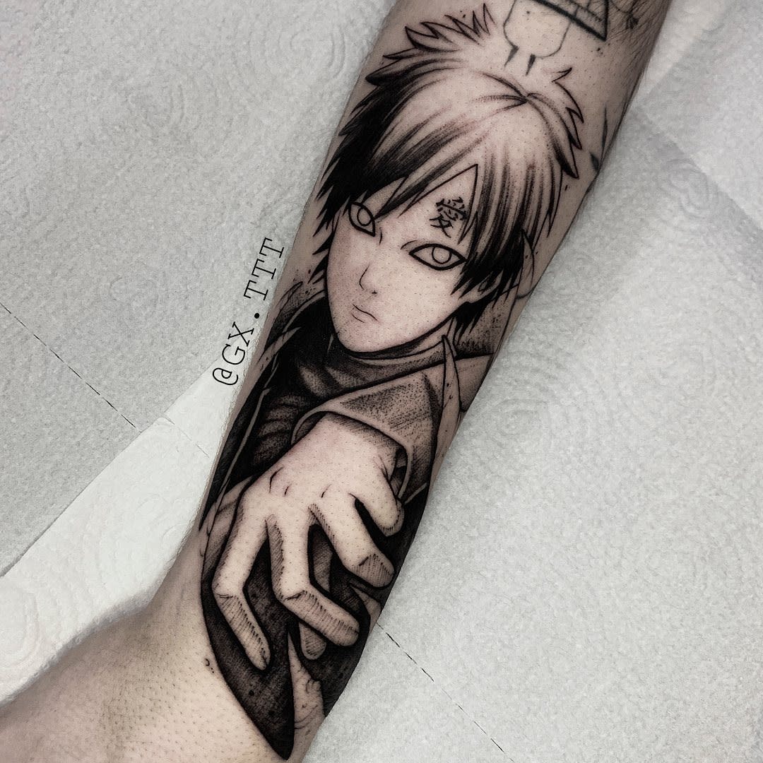 Tattoo of an anime character with spiky hair and an intense expression on a forearm