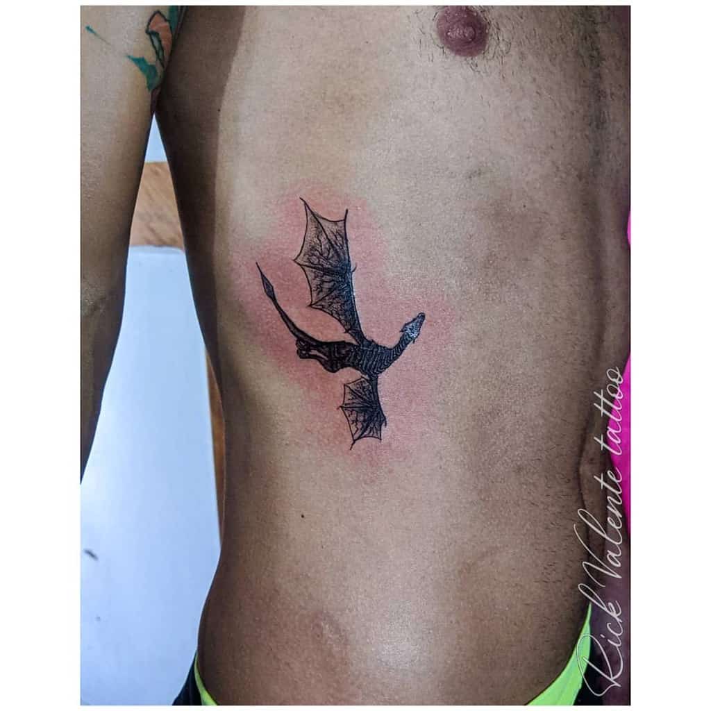 Tattoo of a dragon on a person's side