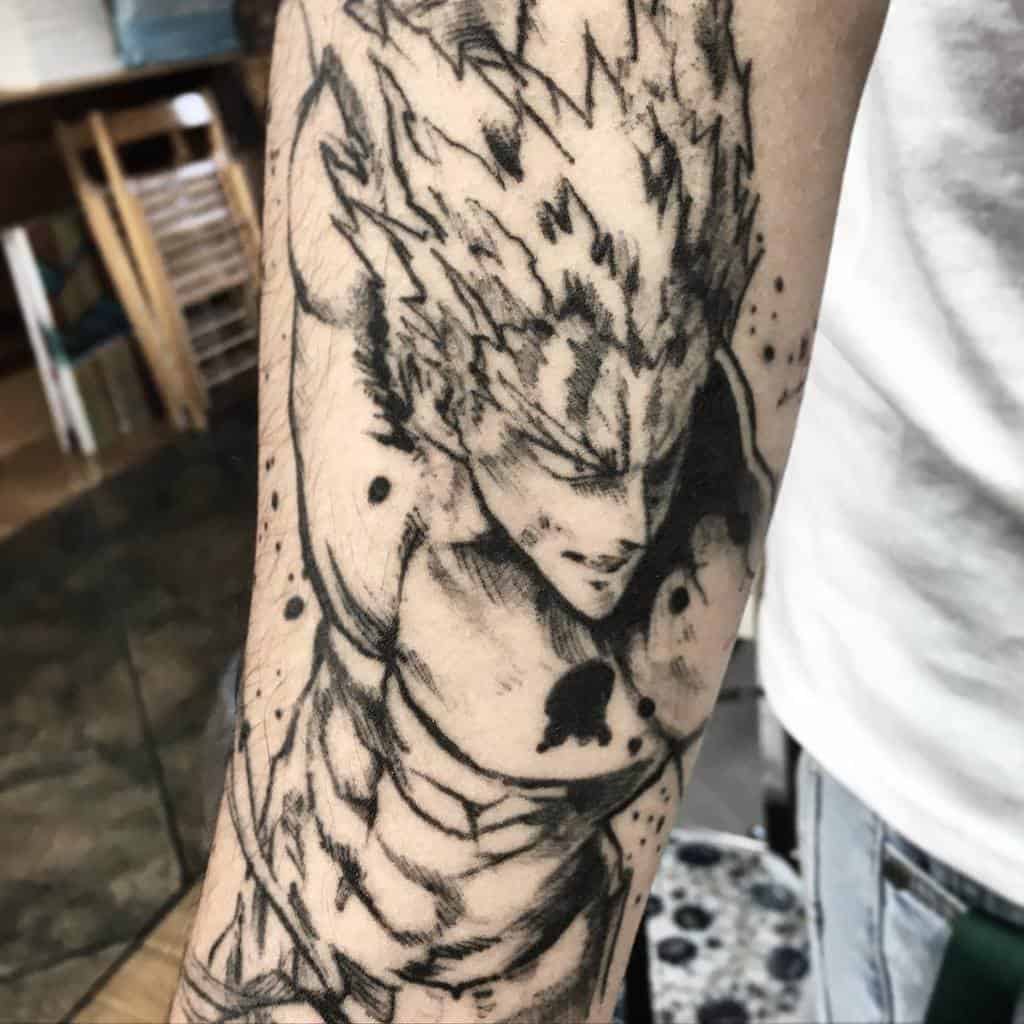A black and gray tattoo of Garou from One Punch Man in a battle-ready pose, with dynamic shading and ink splatter effects