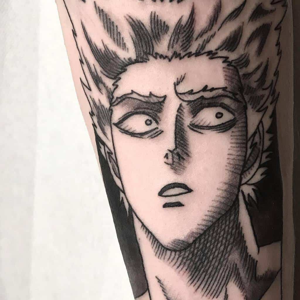 A black and gray manga-style tattoo of Garou from One Punch Man with a shocked expression, featuring bold shading and fine details