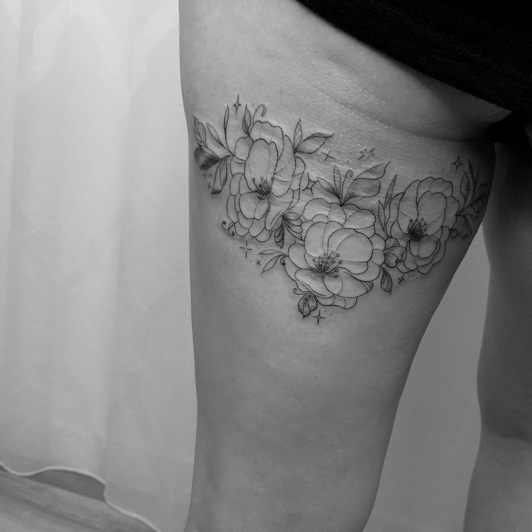 Black-and-white tattoo of peony flowers on thigh, featuring detailed petals and leaves