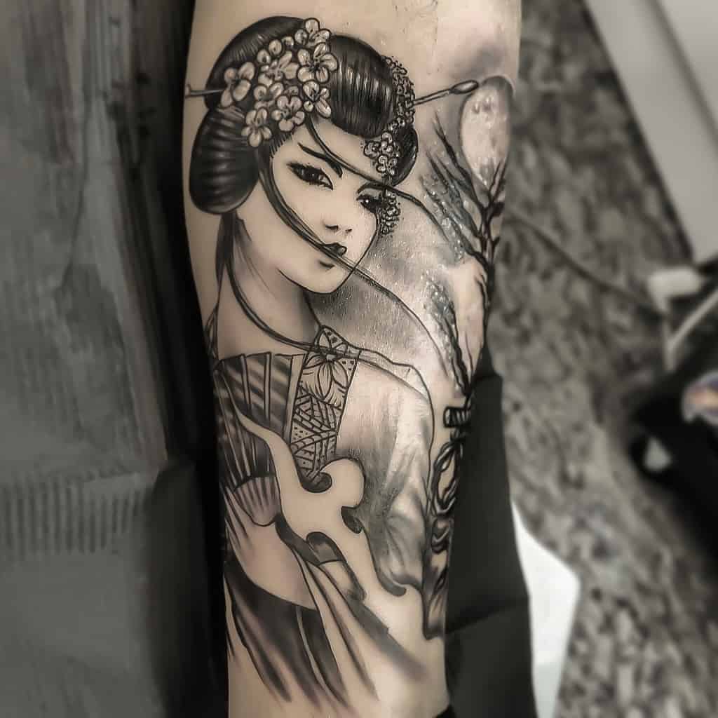 Black and gray tattoo of a Geisha with floral hair ornaments, a traditional kimono, and a serene background featuring a moonlit tree.