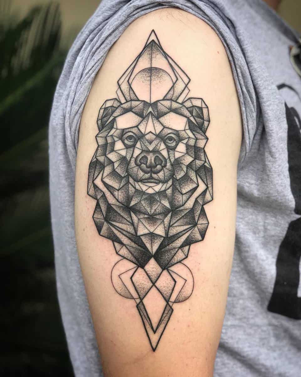 Geometric bear tattoo on upper arm with intricate nature-inspired elements