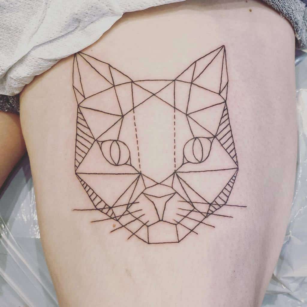 Geometric tattoo in the shape of a cat with intricate line patterns on a person's thigh