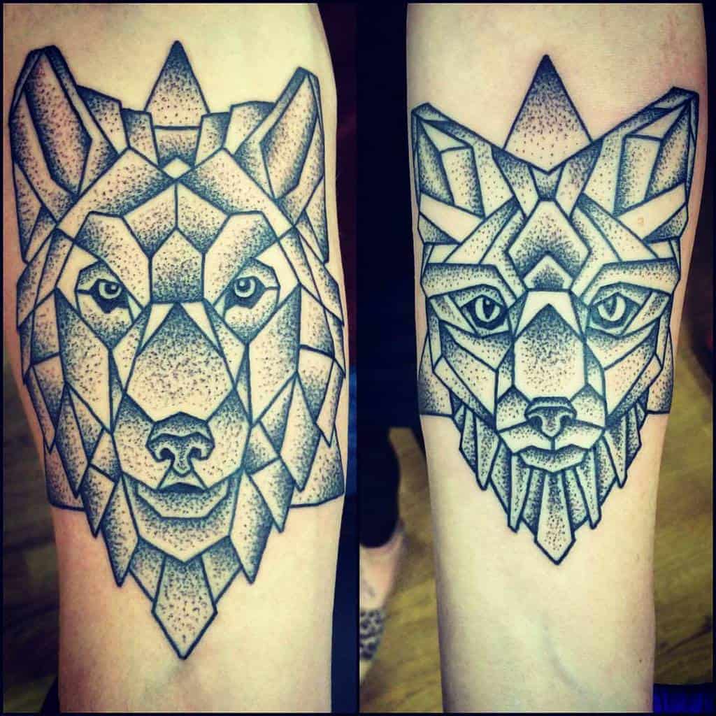 Geometric tattoos of a wolf and a fox on forearms in black and white ink