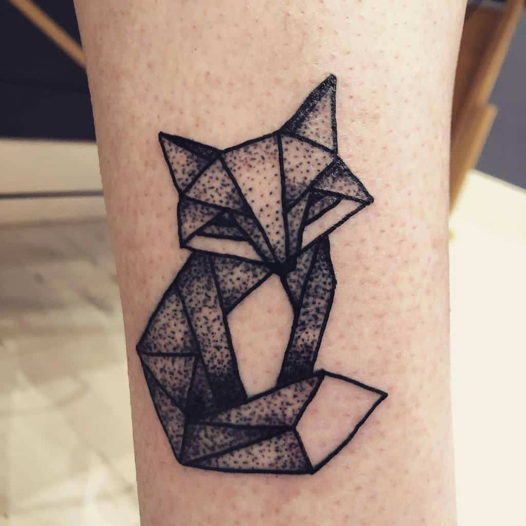 Geometric fox tattoo with black lines and shaded geometric triangles