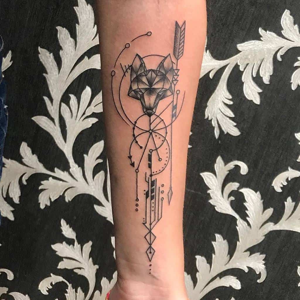 Geometric fox tattoo with tribal elements on a forearm