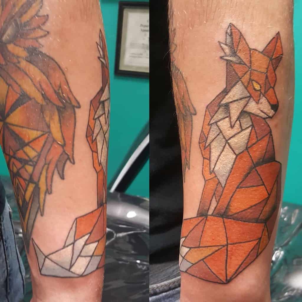Geometric fox tattoo with vibrant orange and brown tones on a person's arm