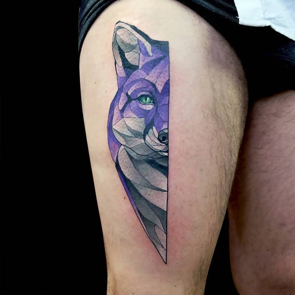 Geometric fox tattoo in shades of purple, blue, and gray on a person's upper thigh
