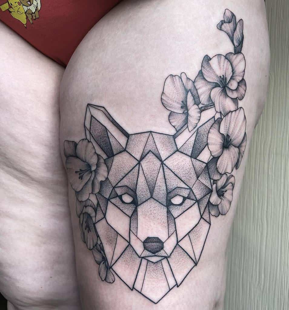 Geometric fox tattoo intertwined with flowers on a person's upper thigh