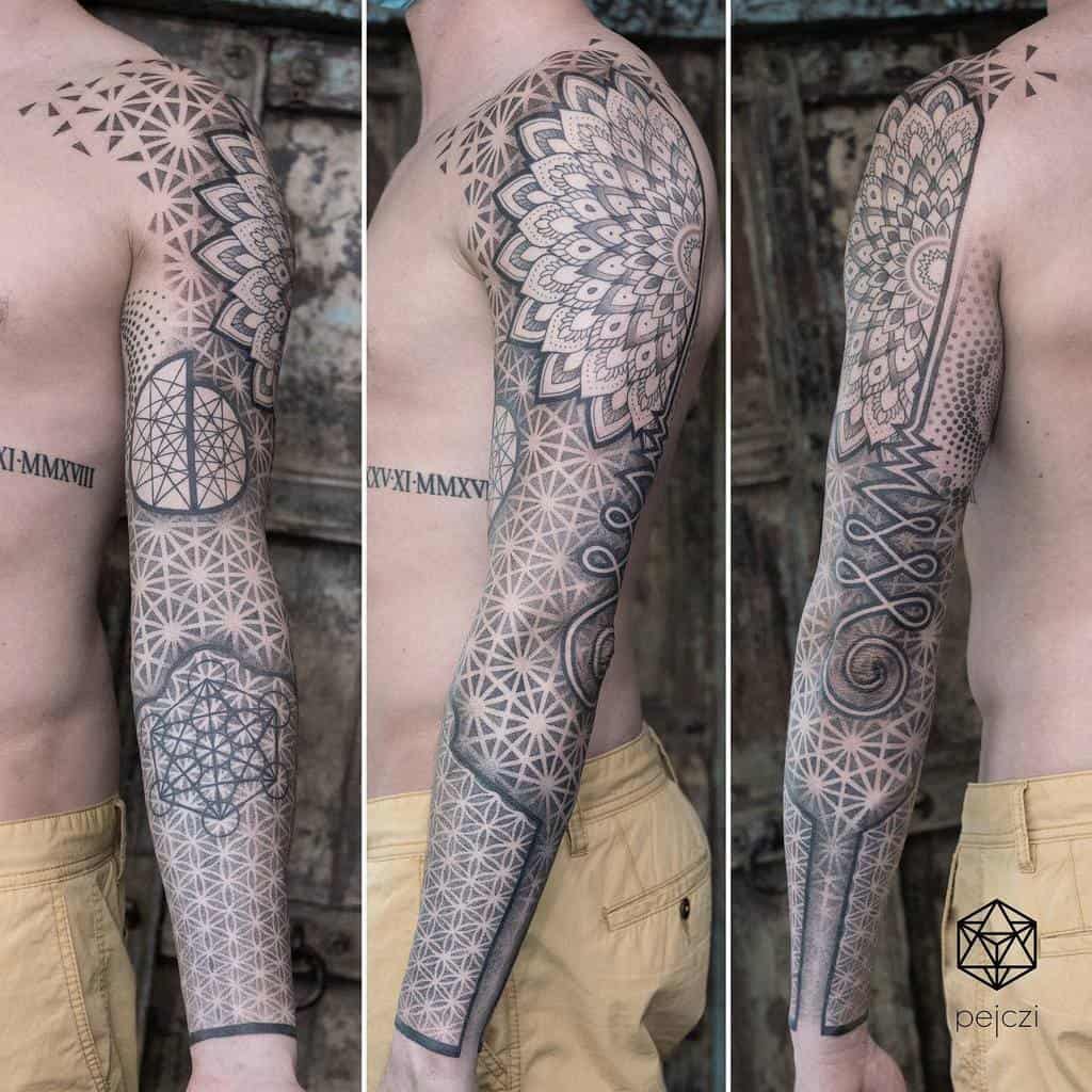 A full sleeve geometric tattoo featuring intricate mandala designs on the shoulder, repeating patterns along the arm, and detailed linework extending from the upper arm to the wrist