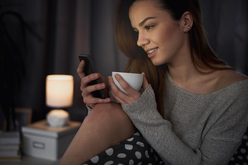 Girl Looking At Phone At Night